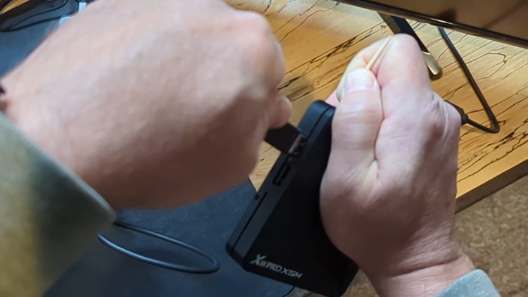 Insert toothpick into AV hole and connect PC