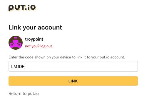 Visit put.io/link and enter the provided code.